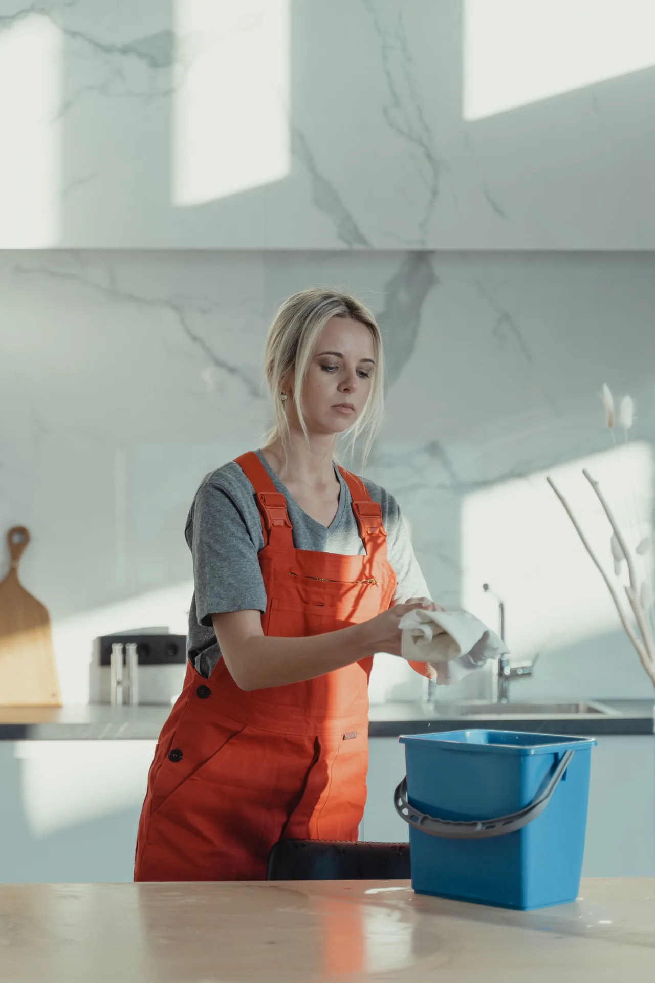 Cleaner wiping kitchen surfaces