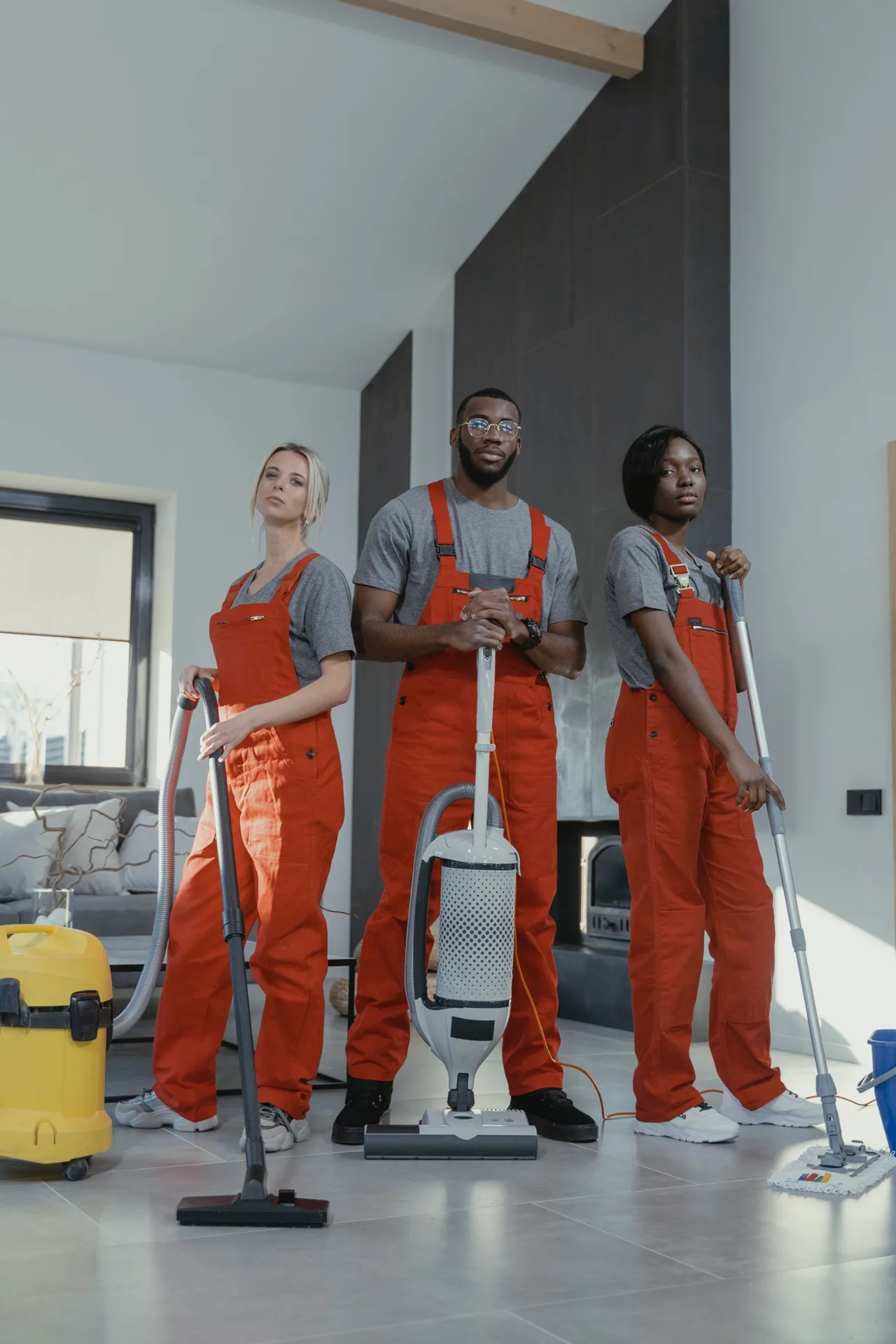 Cleaning team with equipment in a modern living room